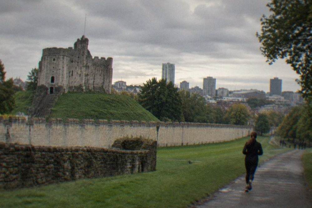 Cardiff Castle keep with the city skyline behind it on a bright morning