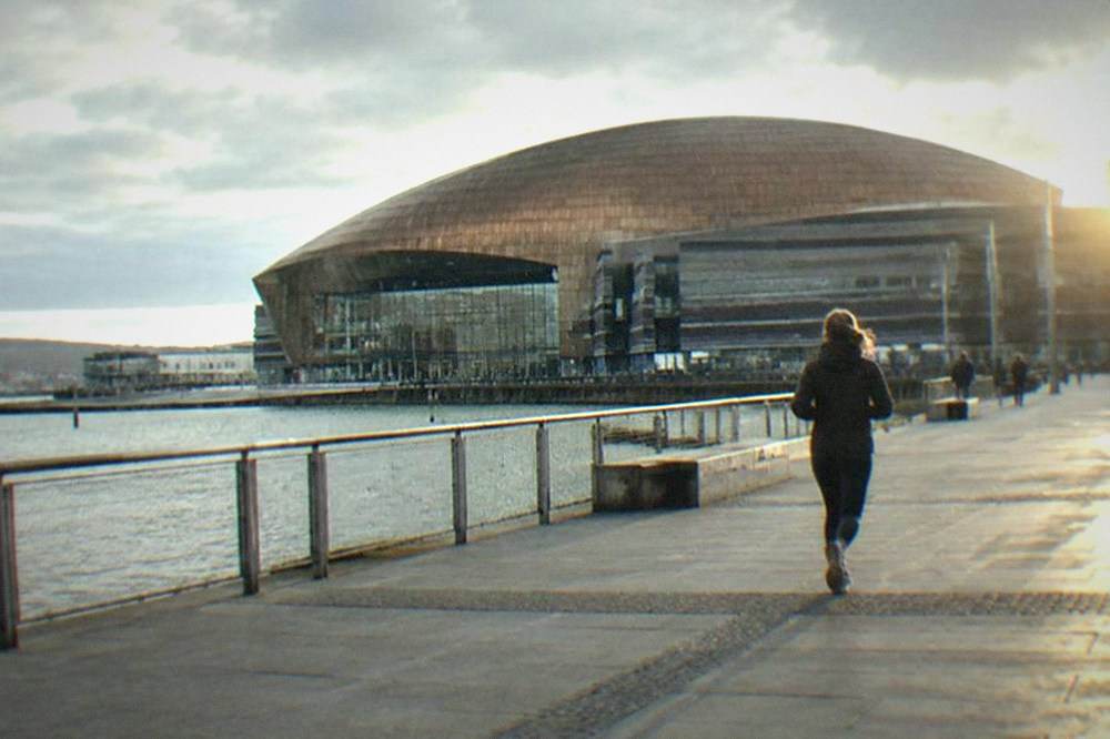 The Wales Millennium Centre facade across the water at Cardiff Bay