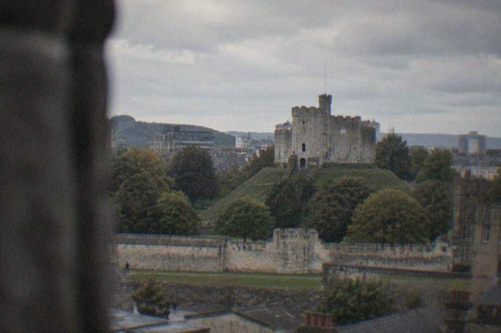 Cardiff Castle keep rising above the city rooftops on a bright afternoon