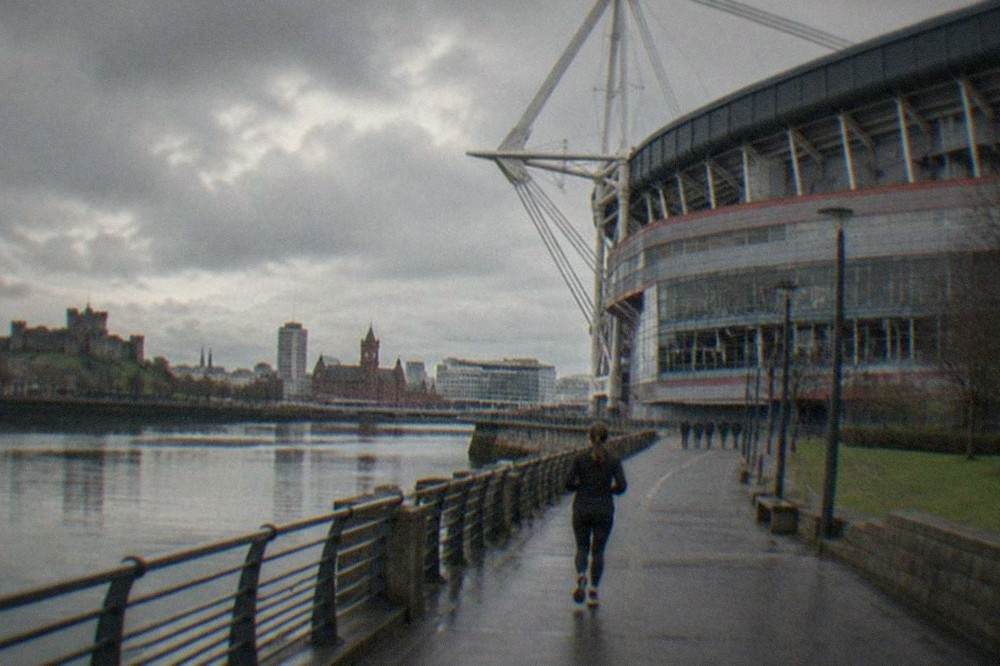 Cardiff city centre skyline with the Principality Stadium and castle green in the foreground
