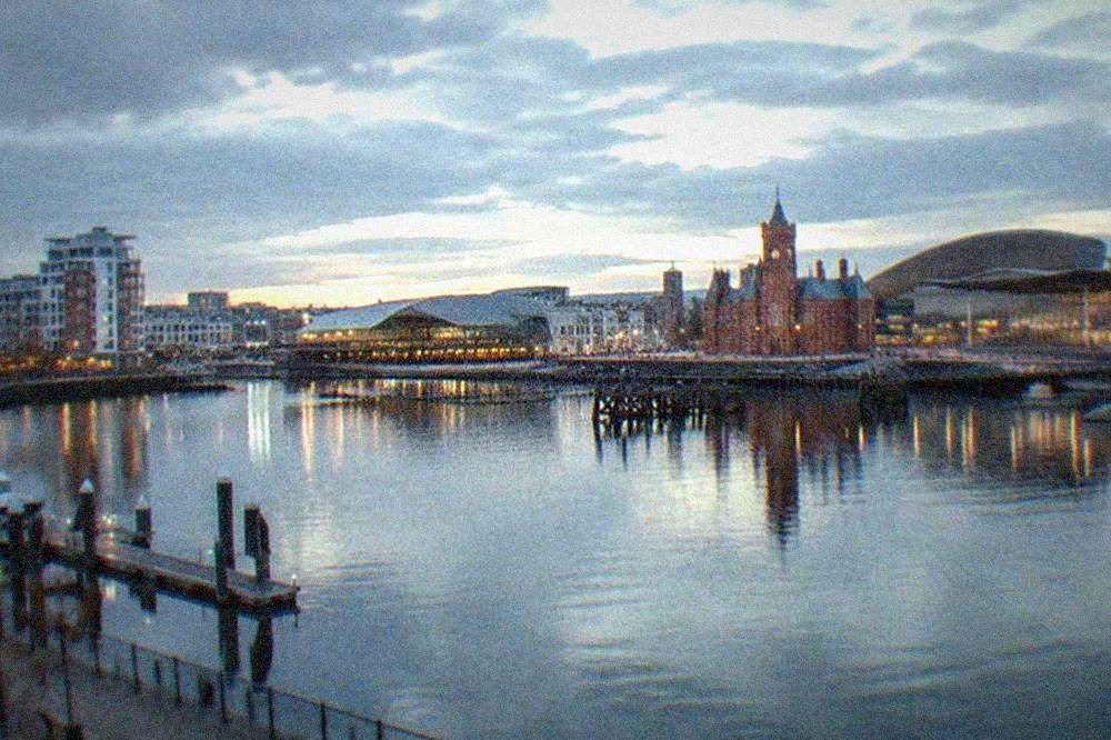 The waterfront buildings of Cardiff Bay reflected in the dock water