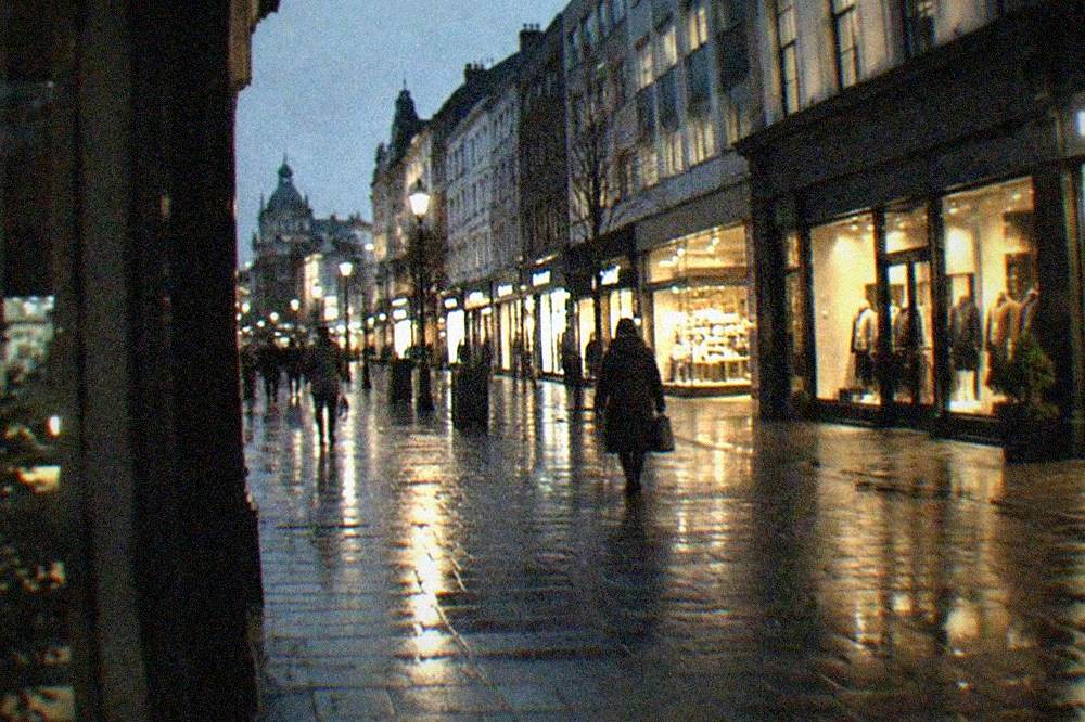 The southern end of St Mary Street in Cardiff with illuminated shopfronts at night