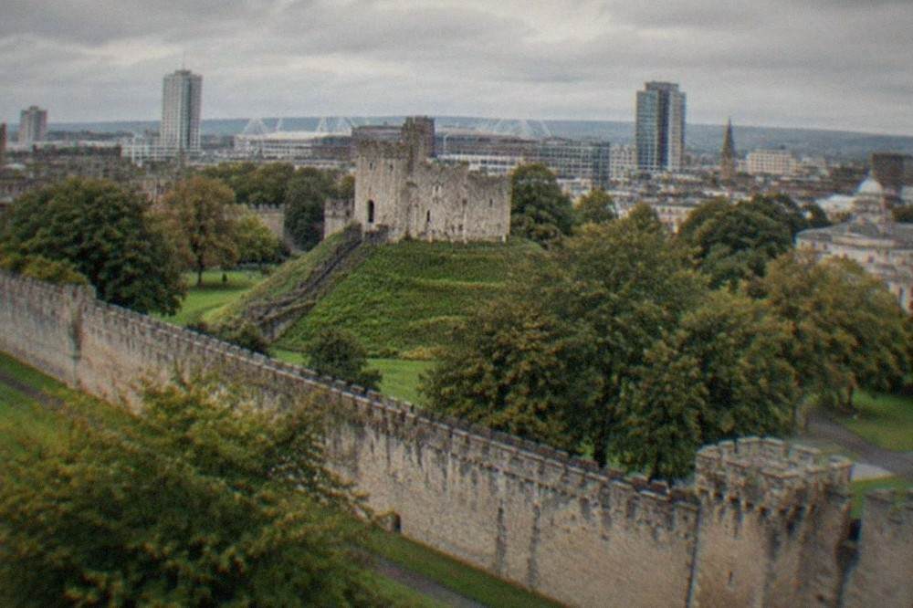 Cardiff Castle keep rising above the city skyline on a bright afternoon