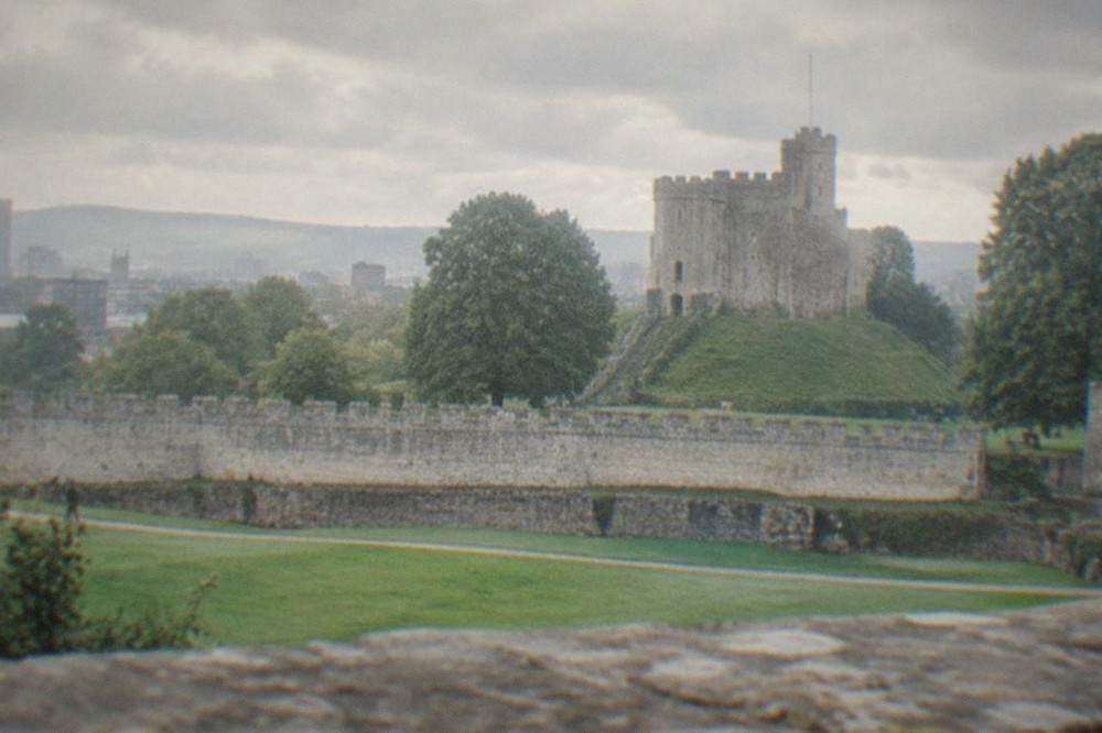 Cardiff Castle Norman keep rising above the city skyline with the green lawns of the castle grounds below