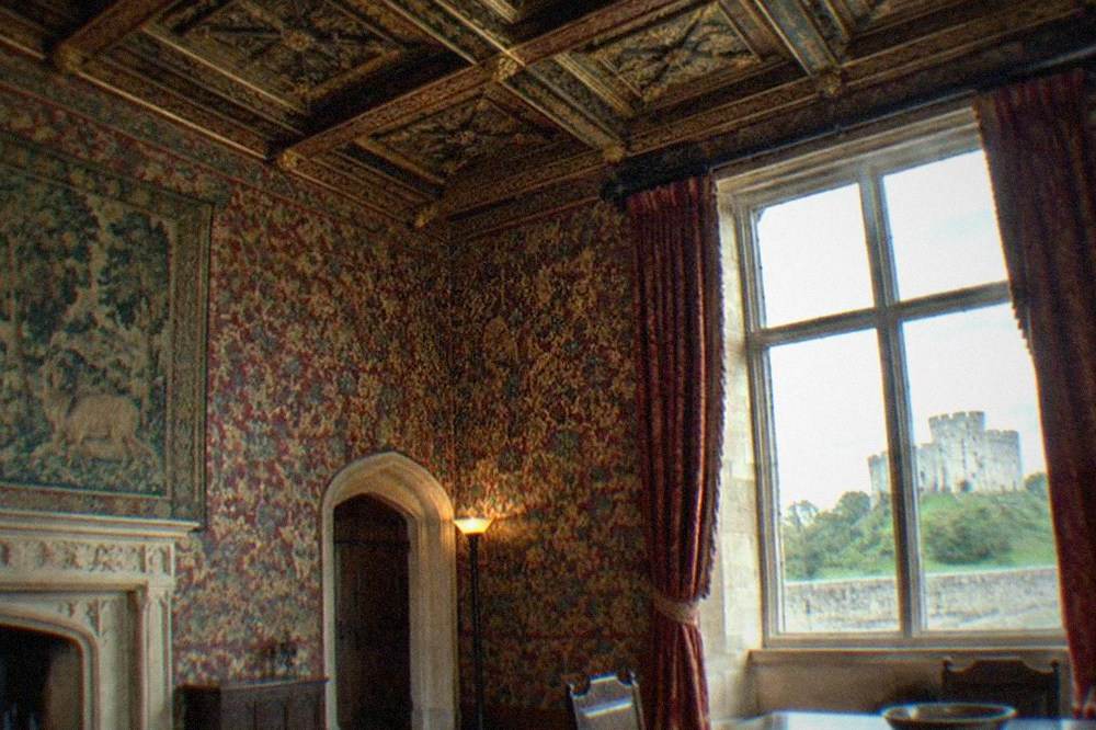 Ornately decorated interior of the castle apartments with carved ceiling details and richly patterned walls