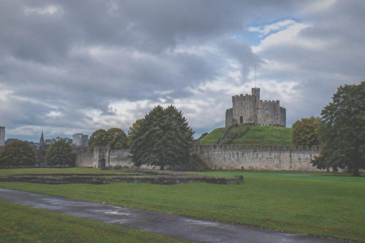 Cardiff Castle Norman keep rising above the city skyline with the green lawns of the castle grounds below