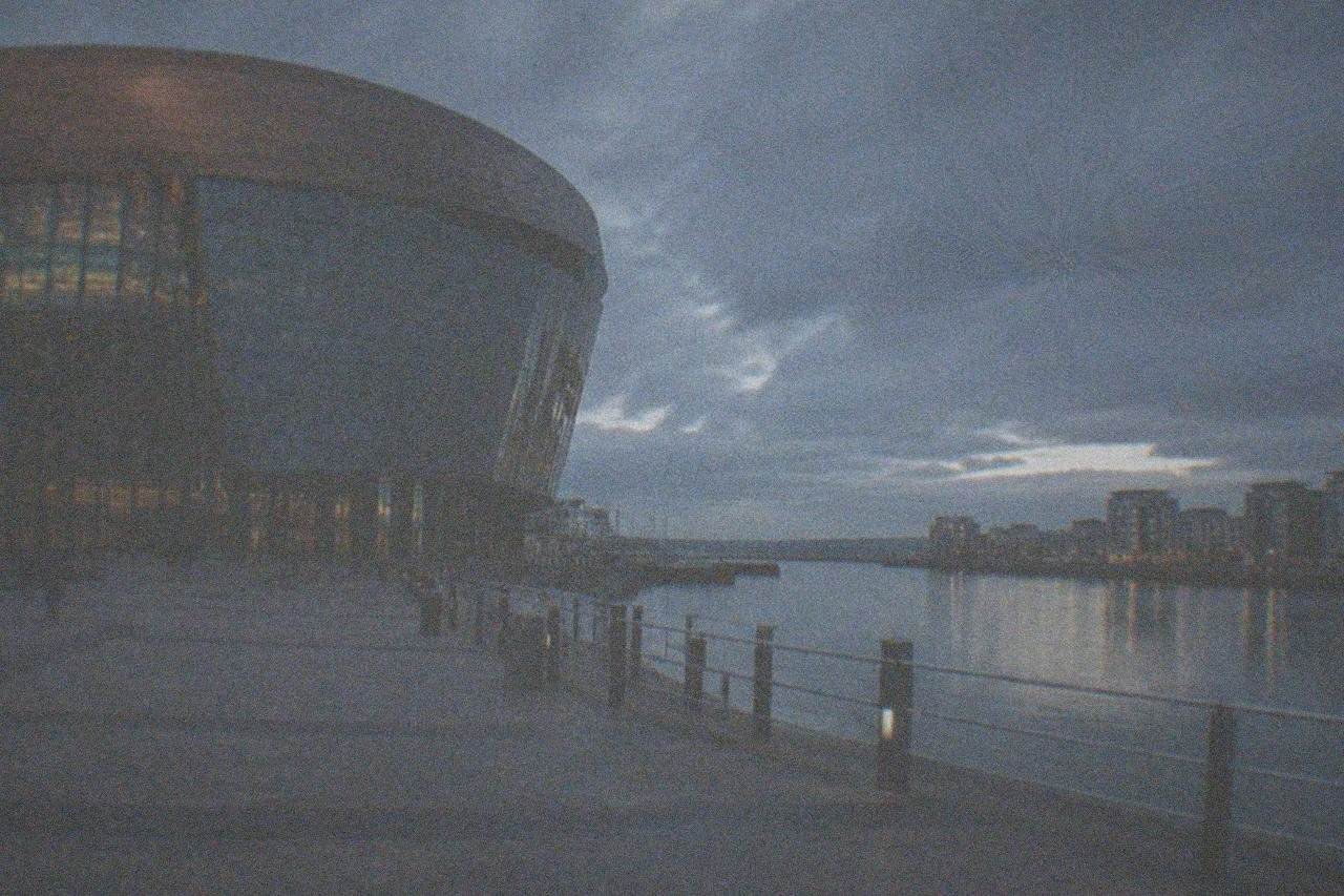 Cardiff Bay waterfront with the Wales Millennium Centre and calm harbour water