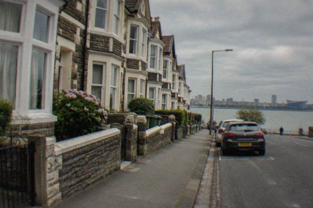 A row of Victorian terraced houses with bay windows on a Cardiff street