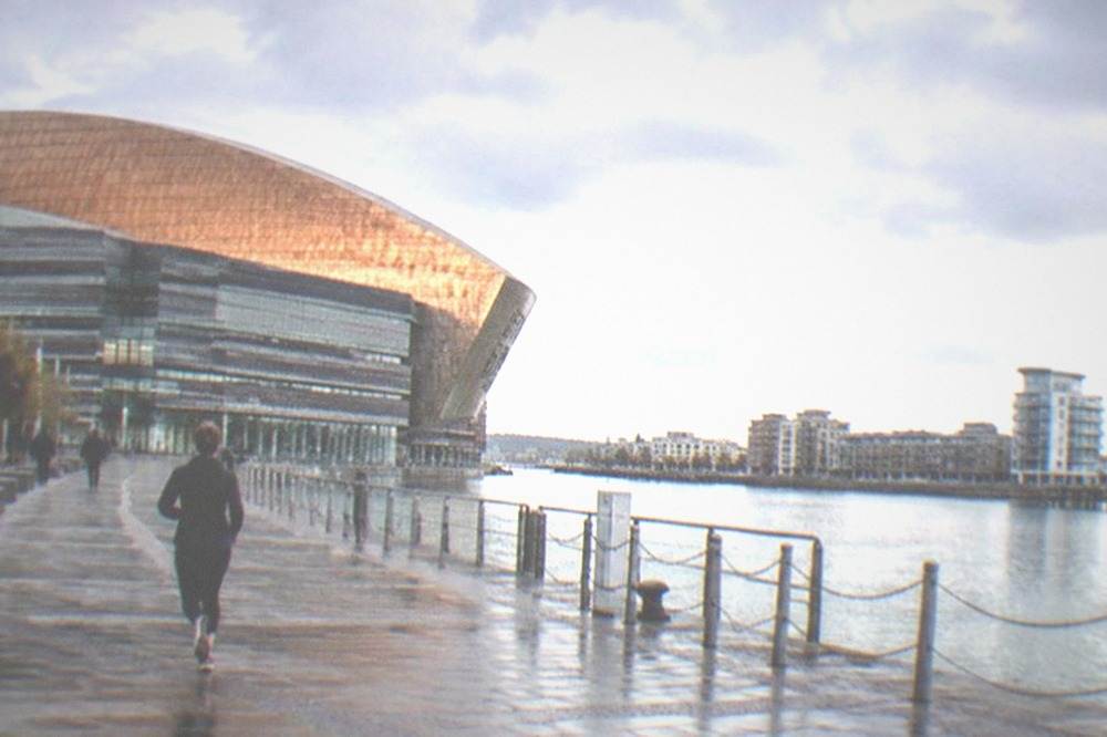 The Cardiff Bay waterfront with the Wales Millennium Centre and harbour buildings across calm water