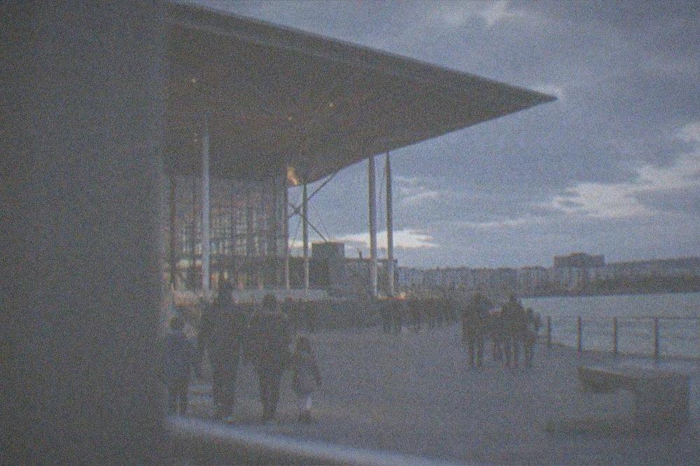 Families walking along the wide promenade outside the Senedd