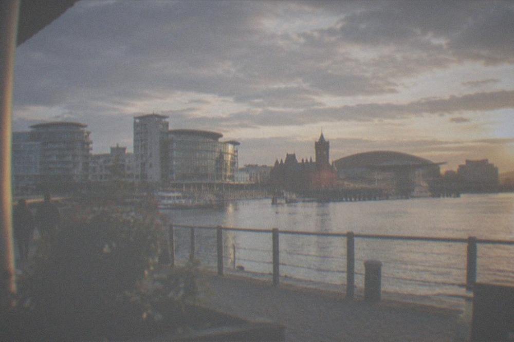Waterfront promenade in Cardiff Bay with modern buildings along the shore