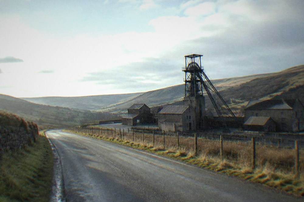 Empty moorland road climbing through the Welsh valleys in morning light