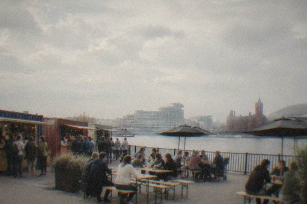 Street food containers at Cardiff Bay with tables and diners