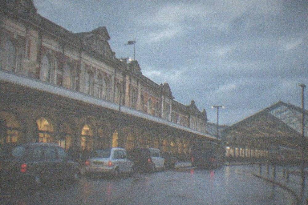 Long-distance train waiting at a platform under a glazed station roof