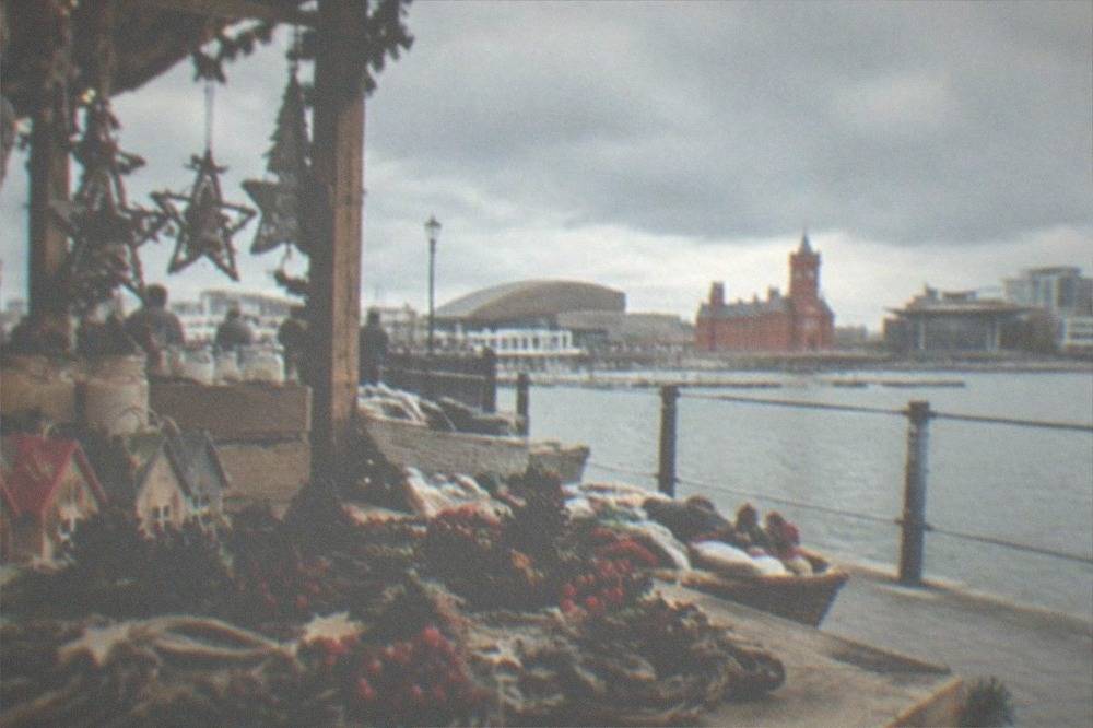 Handmade crafts and festive decorations displayed on a wooden market stall