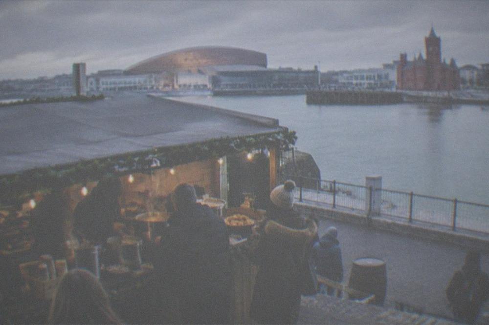 Mulled wine and hot food being served at an outdoor market stall