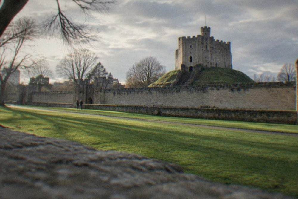 Cardiff Castle walls and green lawns on a bright morning in the city centre