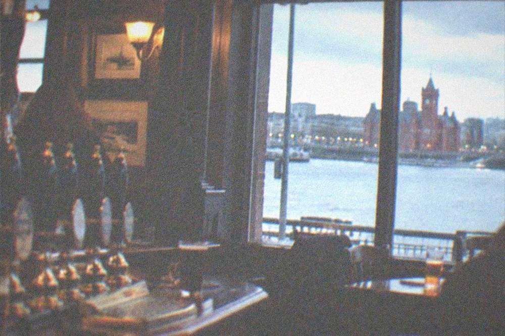 Traditional city pub interior with wooden bar and hand pulls for real ale
