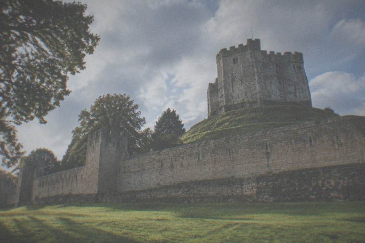 Cardiff Castle walls and green lawns on a bright morning in the city centre