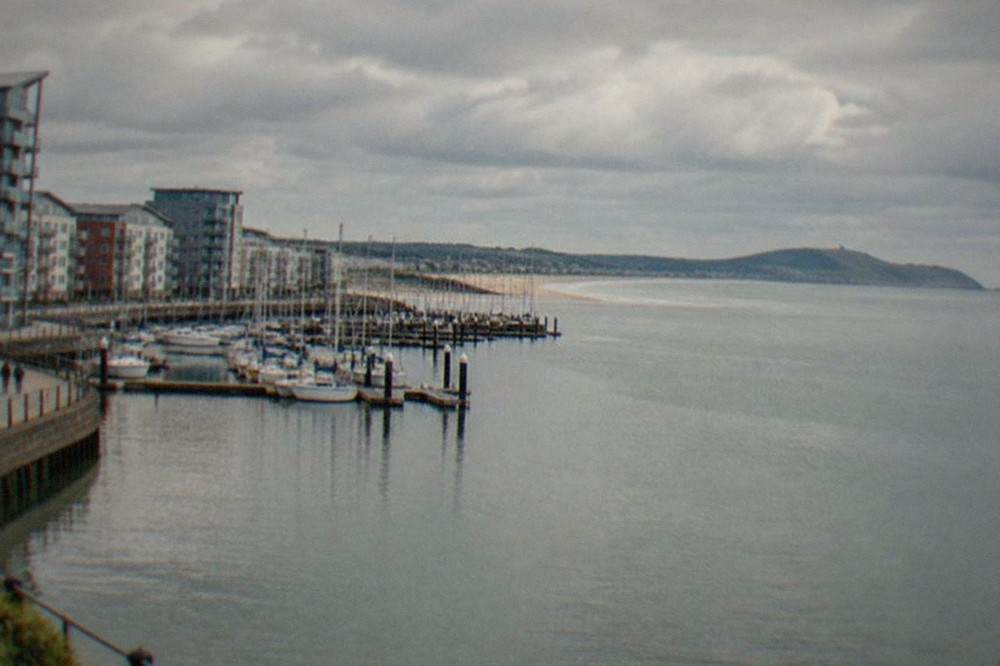Swansea Bay curving toward the Mumbles headland under a wide sky
