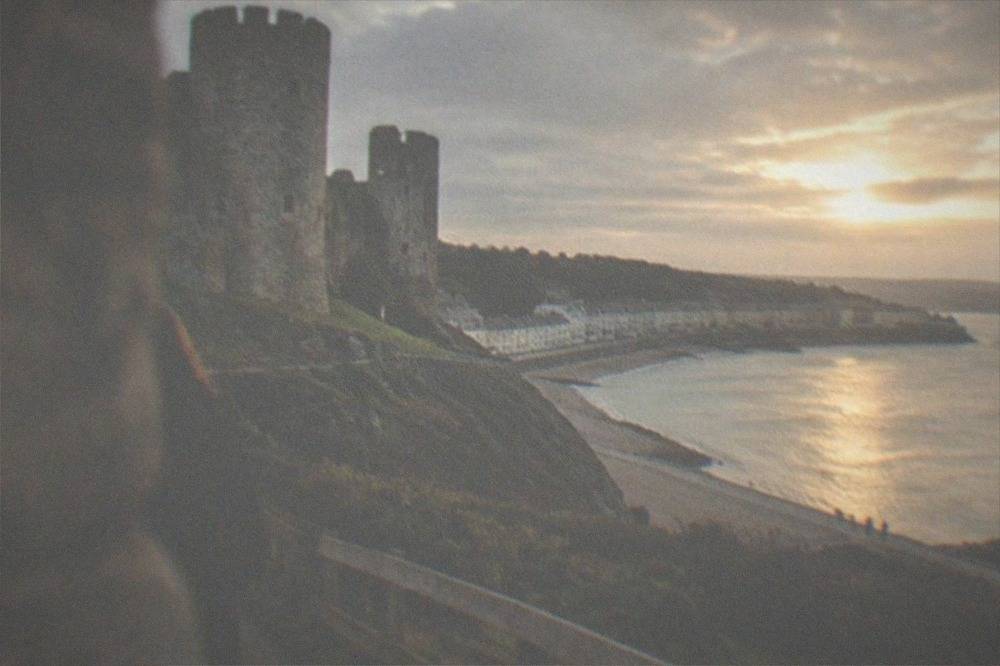 Stone towers of Oystermouth Castle above the Mumbles seafront