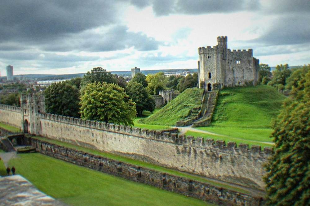 Rain clouds gathering over Cardiff Castle keep and green lawns