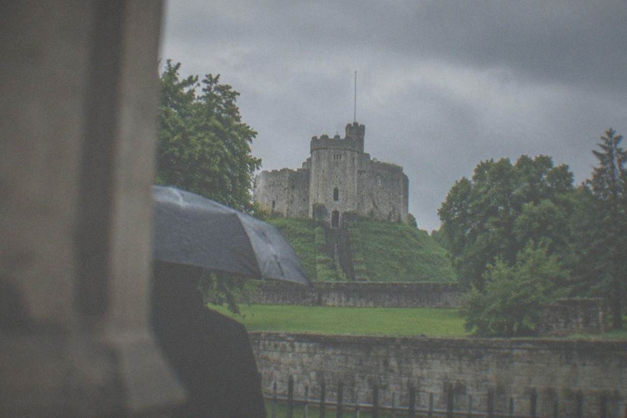Cardiff Castle keep rising above green parkland on a bright day