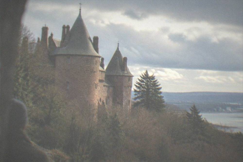Castell Coch turrets rising above steep wooded hillside