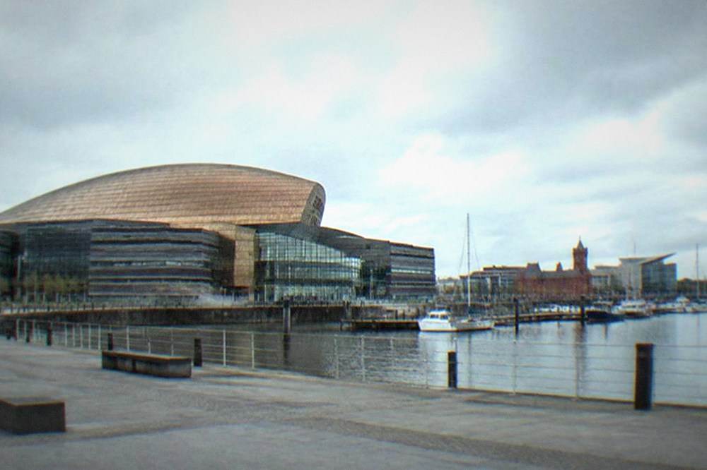 Cardiff Bay waterfront with the Wales Millennium Centre and boats moored at the quayside