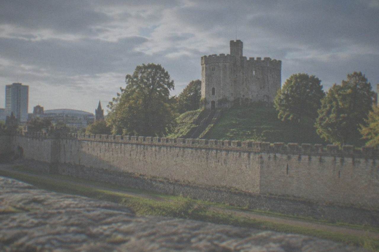 Cardiff Castle keep rising above the city skyline on a bright afternoon