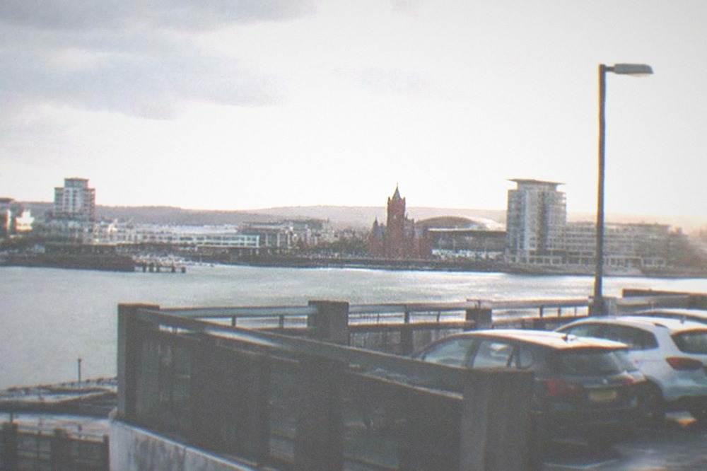 Multi-storey car park exterior with parked cars on open decks