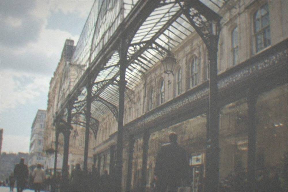 Cardiff city street with Victorian arcades and shoppers in daytime