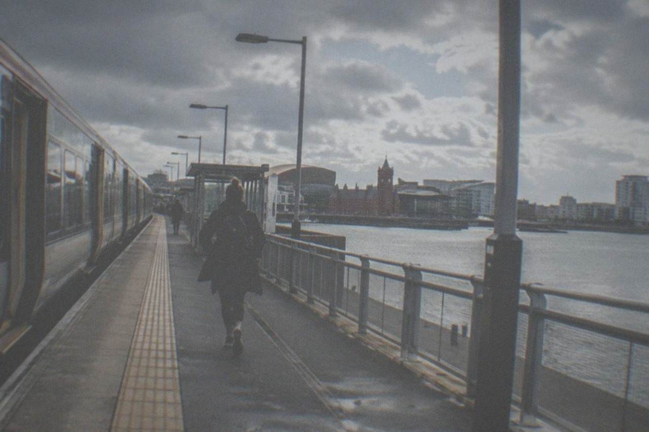 A intercity train standing at a platform beside a city station