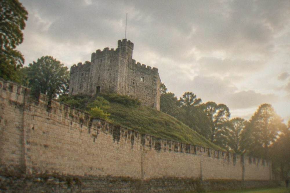 Cardiff Castle keep with Bute Park trees behind it at golden hour