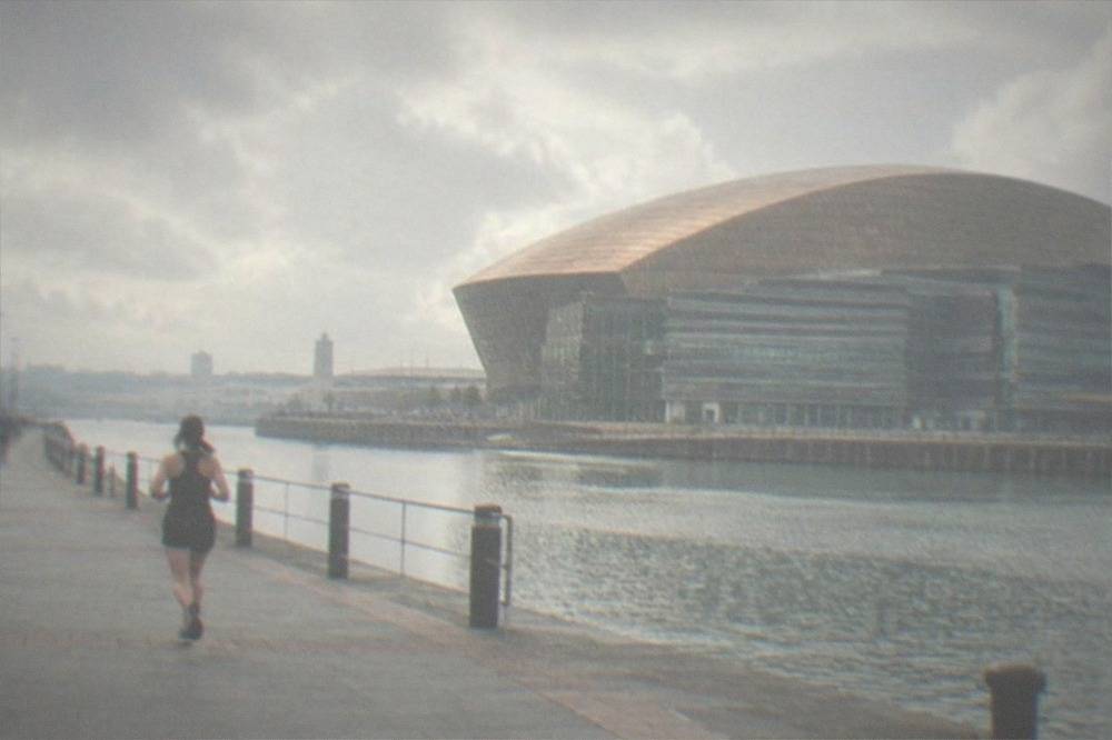 Cardiff Bay waterfront with the Wales Millennium Centre across still water