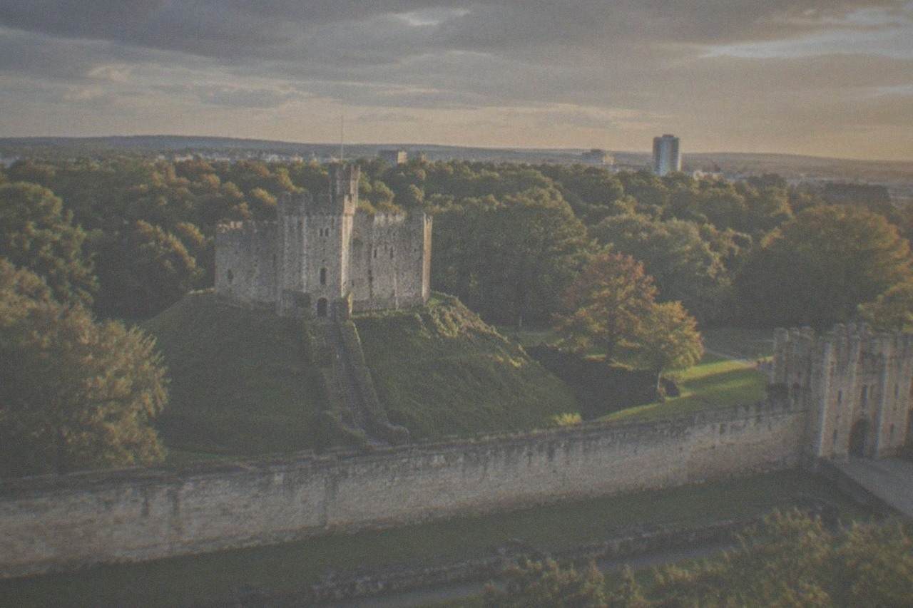 Cardiff Castle keep with Bute Park trees behind it at golden hour