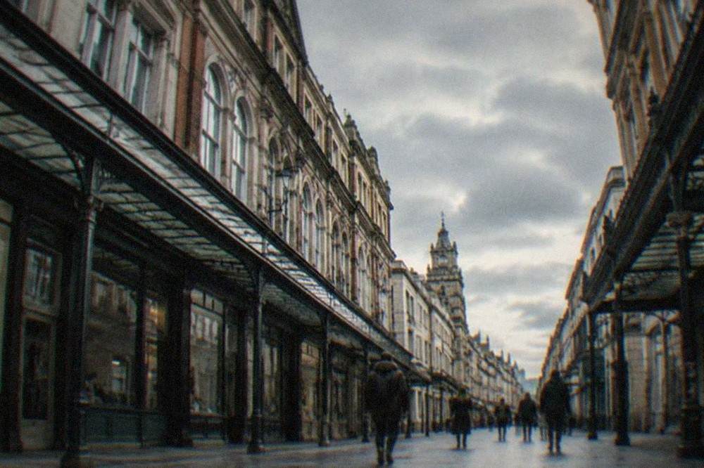 A pedestrianised shopping street in central Cardiff lined with Victorian arcades and shopfronts