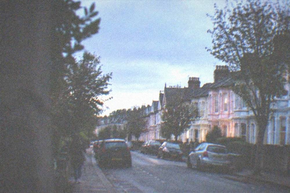 A street of pastel-coloured Victorian terraced houses in Pontcanna with trees