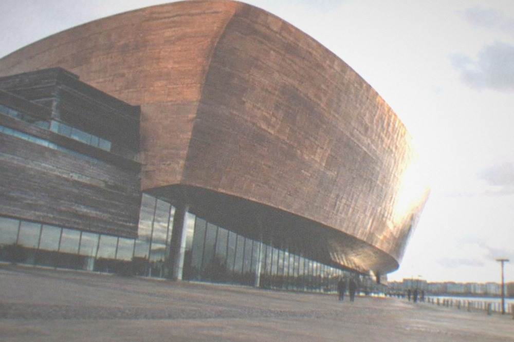 The copper-fronted Wales Millennium Centre beside the water at Cardiff Bay