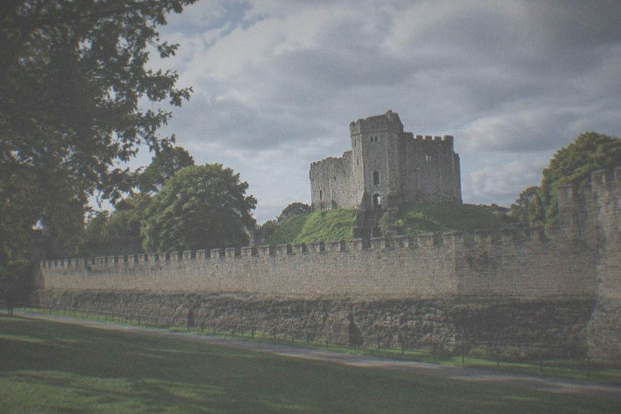 Cardiff Castle keep rising above green lawns in the city centre