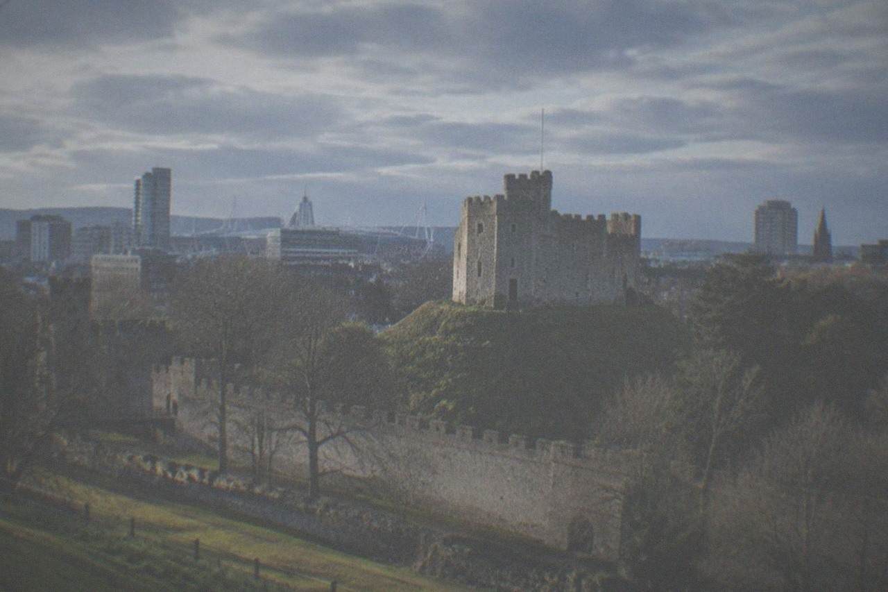 Cardiff Castle keep with the city skyline behind it on a bright morning