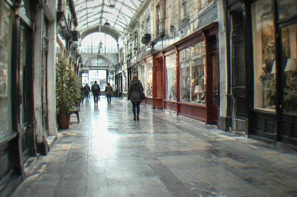Victorian shopping arcade interior with shopfronts and glass roof