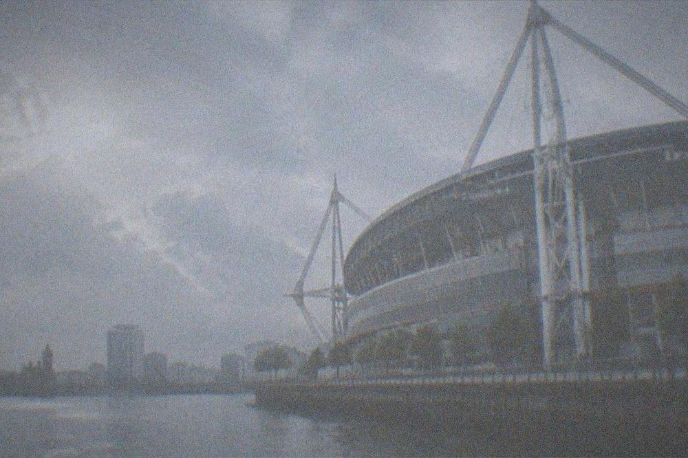 Cardiff city skyline at dusk with the Principality Stadium roof